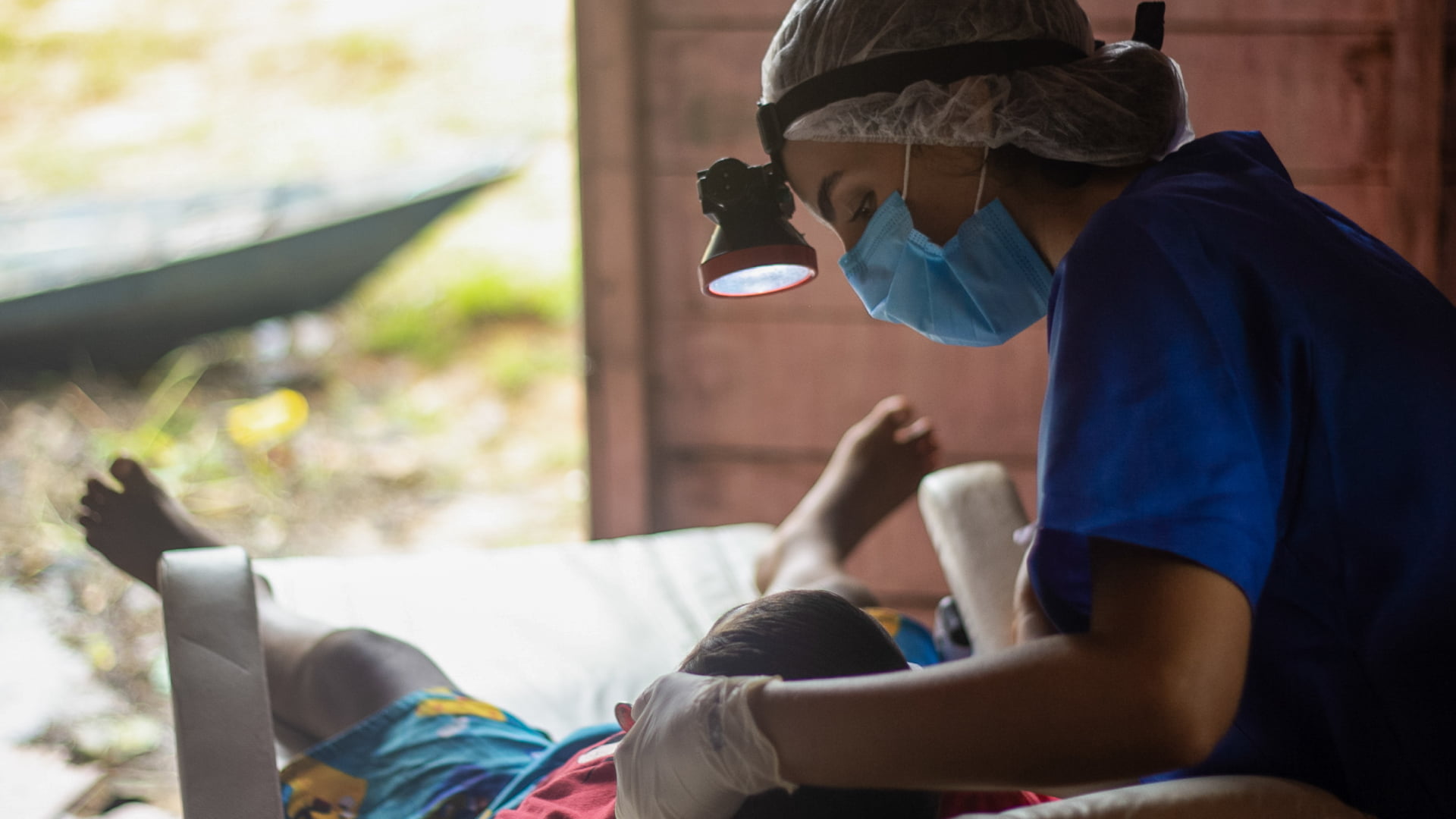 Uma médica atendendo um menino na cadeira